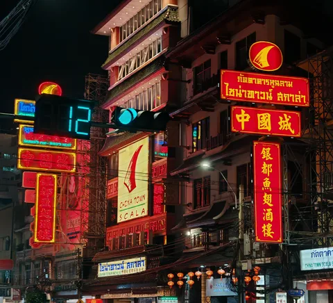 Yaowarat neon and evening Chinatown street activity.