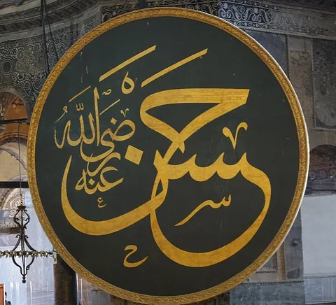 Historic calligraphic roundel and Byzantine/Ottoman architectural layers inside Hagia Sophia, August 2026.