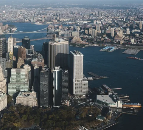 Lower Manhattan towers, harbour and East River from an elevated viewpoint.