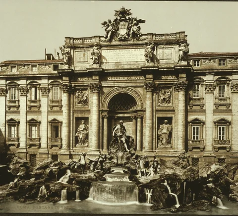 Trevi Fountain in a historic colour photochrom photograph, circa 1890–1900.