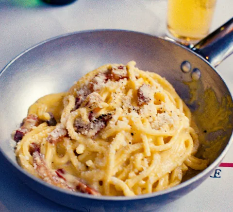 Carbonara served in a pan at source-identified Osteria Nannarella, Rome.