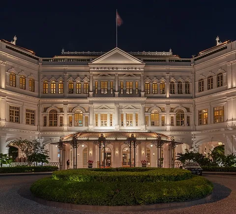 Raffles Hotel exterior facade at night in August 2023.