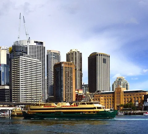 Manly ferry on Sydney Harbour against the Circular Quay skyline.